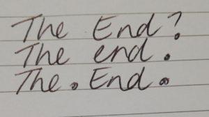 A little something about endings. The picture shows a lined page that reads; The End. The End? The. End.
