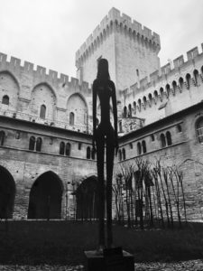 Walking on the dark side: an image of a lone female sculpture silhouetted in a courtyard of Avignon castle