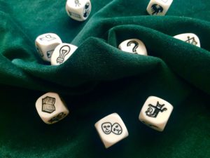 Story cubes, laid out on green velvet. The end is nigh.