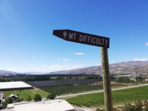 Finding a writing group can be difficult, not unlike this sign post. Photo displaying a signpost to Mt. Difficulty, a mountain on the South Island which is also well known for the prestigious winery there.